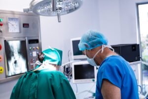 Male and female surgeon working in operation theater